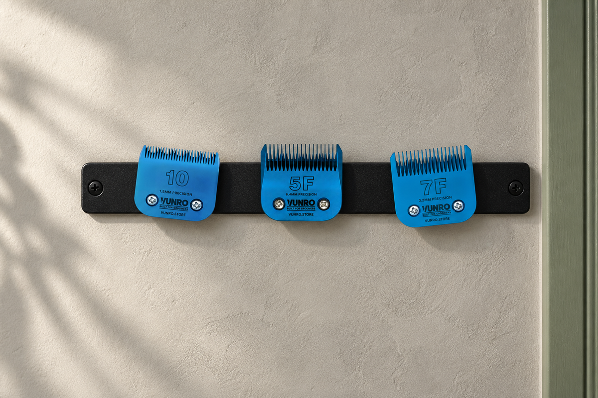 Three VUNRO blue clipper blades secured to a wall-mounted magnetic tool strip